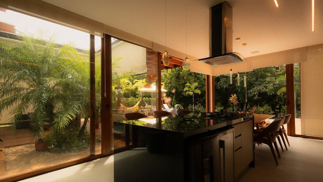 Bright modern kitchen with tropical views and natural wood accents