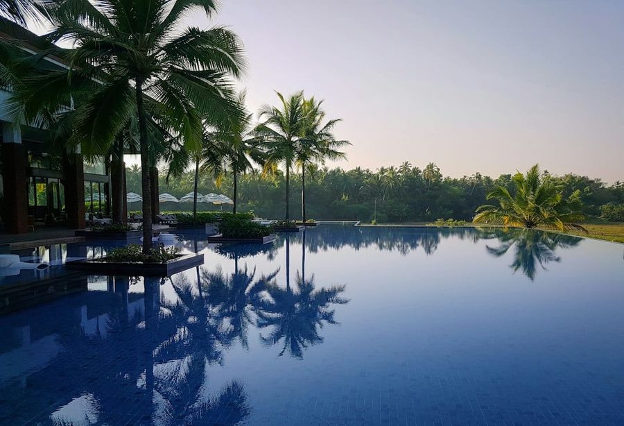 Private swimming pool with sun loungers and tropical greenery