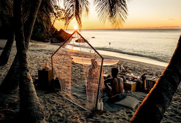 Romantic candlelit dinner on a private beach at sunset