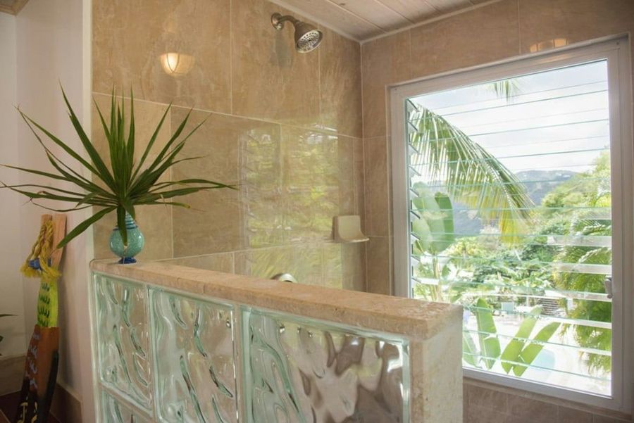Modern bathroom with fresh towels and tropical view