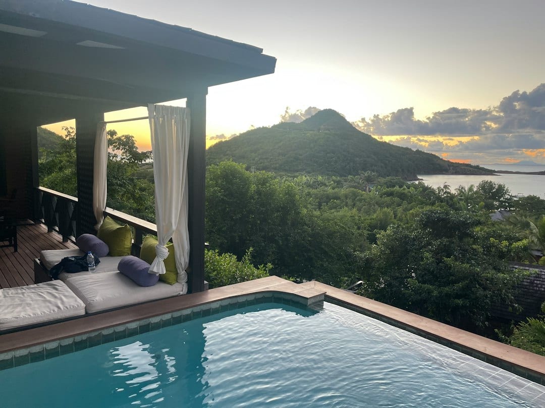 Private pool with sun loungers overlooking tropical garden